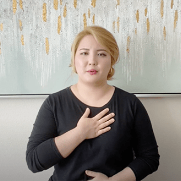 Occupational therapist shows hand-on-chest posture to promote inner peace, healing, and relaxation